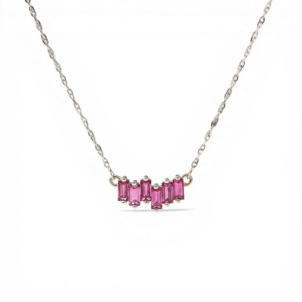 Sophia Schneider Joyas 14K gold necklace with a curved row of 5 baguette-cut rhodolite stones.