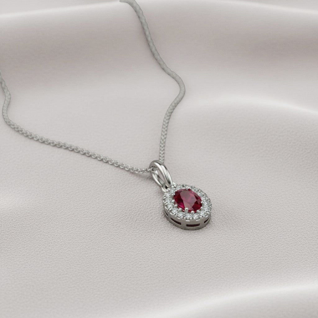 Sophia Schneider Joyas 14K white gold oval ruby and diamond halo pendant necklace.