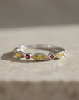 Sophia Schneider Joyas 14K gold ring with alternating marquise-cut yellow sapphires and round rubies.