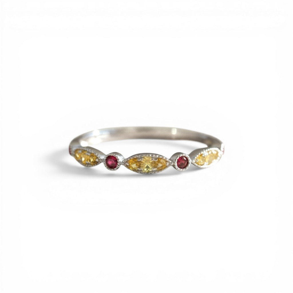 Sophia Schneider Joyas 14K gold ring with alternating yellow sapphires and red rubies, delicate gemstone band.