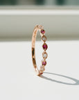 Sophia Schneider Joyas 14K rose gold ring with alternating marquise-cut rubies and round diamonds.