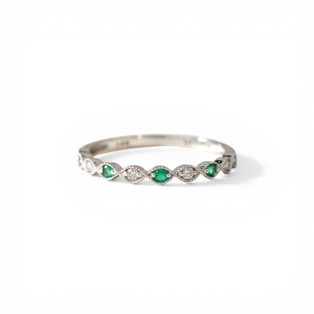 Sophia Schneider Joyas 14K white gold band ring with alternating emeralds and diamonds in a scalloped setting.