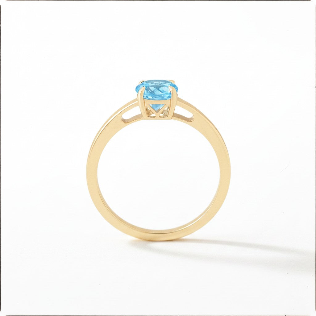 Sophia Schneider Joyas 18K gold ring with a 0.96 ct oval blue topaz gemstone.