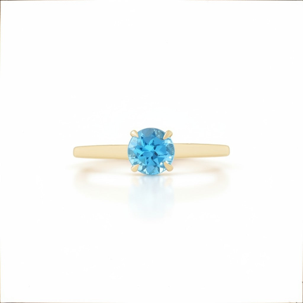 Sophia Schneider Joyas 18K yellow gold ring with a round 0.96 ct blue topaz gemstone.