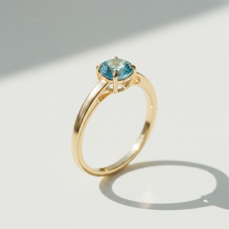 Sophia Schneider Joyas 18K yellow gold ring with a round 0.96 ct blue topaz center stone.