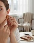 Sophia Schneider Joyas 18K gold curved profile hoop earrings, 15mm diameter, polished finish.