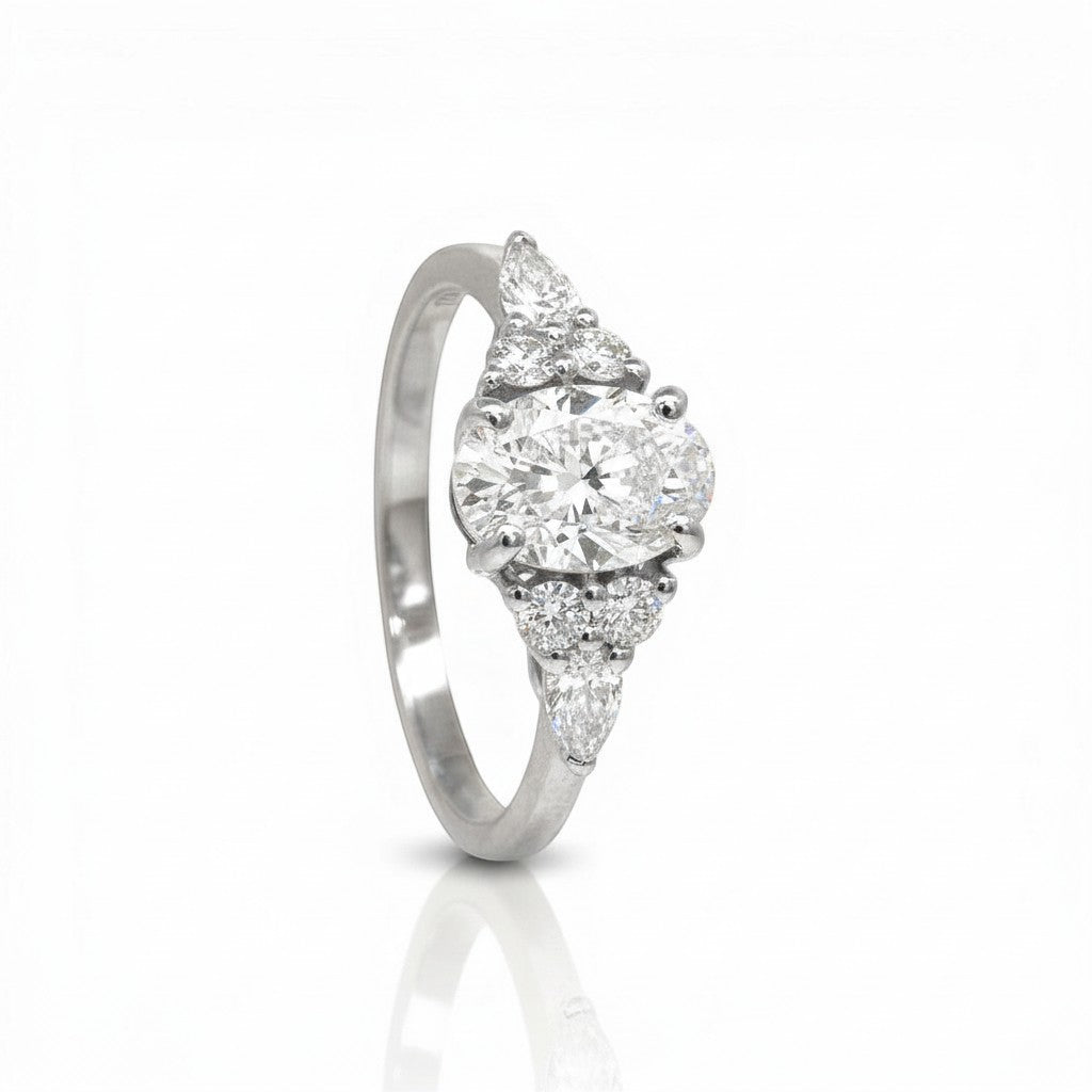 Sophia Schneider Joyas 18K yellow gold ring with oval lab diamond center, marquise and round accent diamonds.