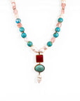 Sophia Schneider Joyas baroque pearl, turquoise, rose quartz, and ruby necklace with 18K gold bezel settings.