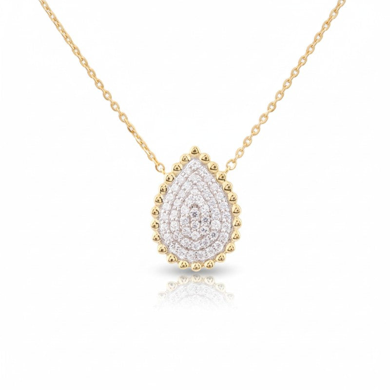 Sophia Schneider Joyas teardrop pendant necklace with lab diamonds and beaded 925 silver setting on a gold chain.