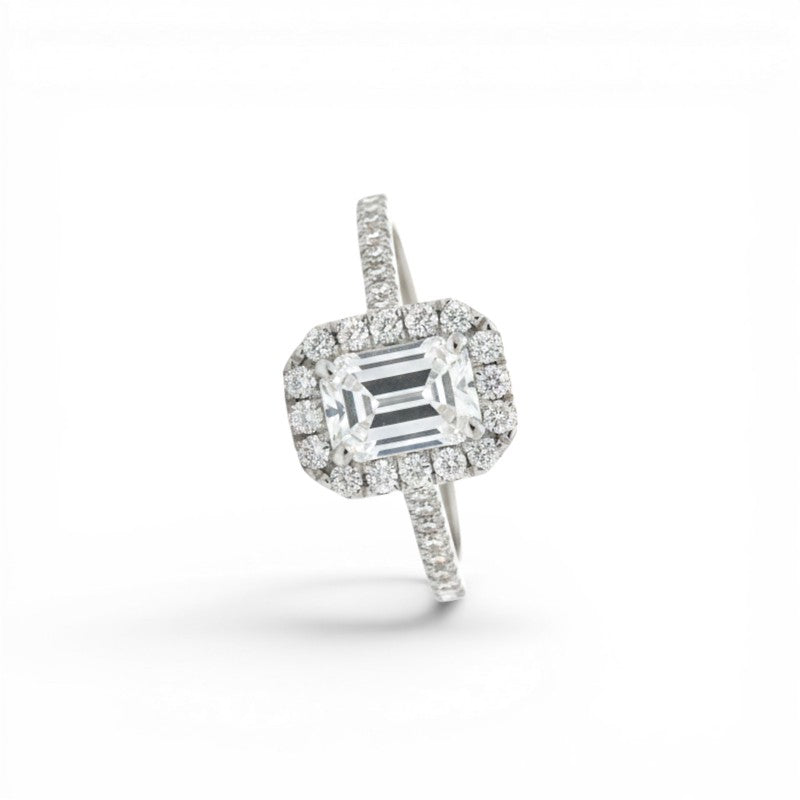 Sophia Schneider Joyas 18K white gold ring with 1.09 ct emerald-cut lab diamond surrounded by a halo and pavé band.