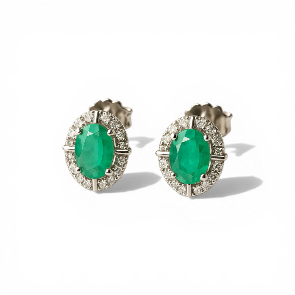 Sophia Schneider Joyas 10K gold oval emerald halo stud earrings with brilliant cut diamonds.