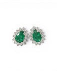 Sophia Schneider Joyas white gold 18K earrings with pear-cut emeralds surrounded by brilliant-cut diamonds.
