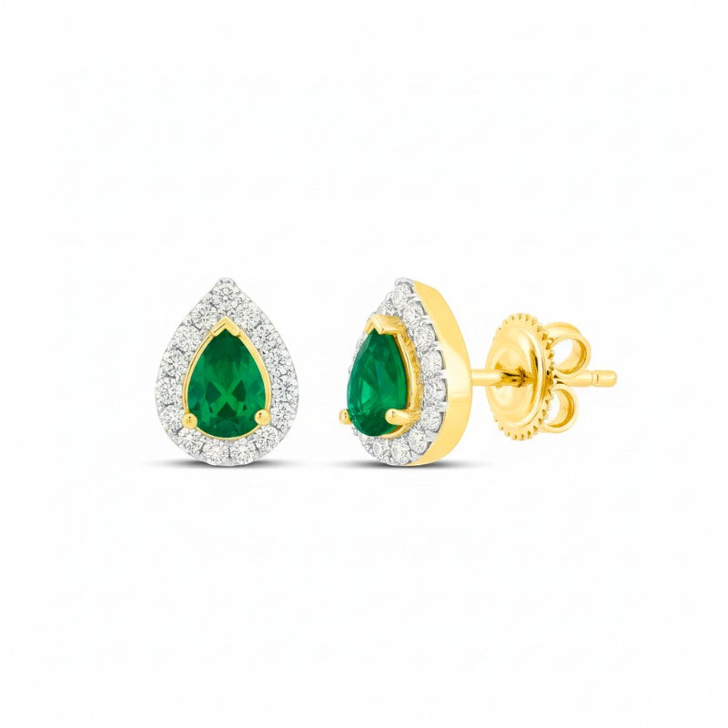 Sophia Schneider Joyas 14K gold stud earrings with pear-cut emeralds surrounded by a halo of small diamonds.