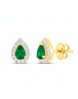 Sophia Schneider Joyas 14K gold stud earrings with pear-cut emeralds surrounded by a halo of small diamonds.