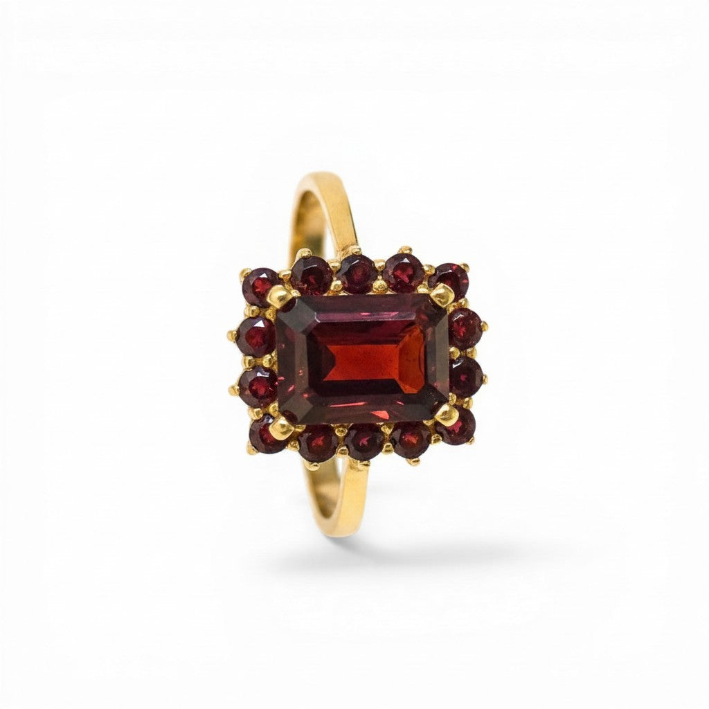 Sophia Schneider Joyas 14K gold ring with a central rectangular garnet surrounded by smaller garnets in a floral cluster design.
