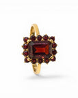 Sophia Schneider Joyas 14K gold ring with a central rectangular garnet surrounded by smaller garnets in a floral cluster design.