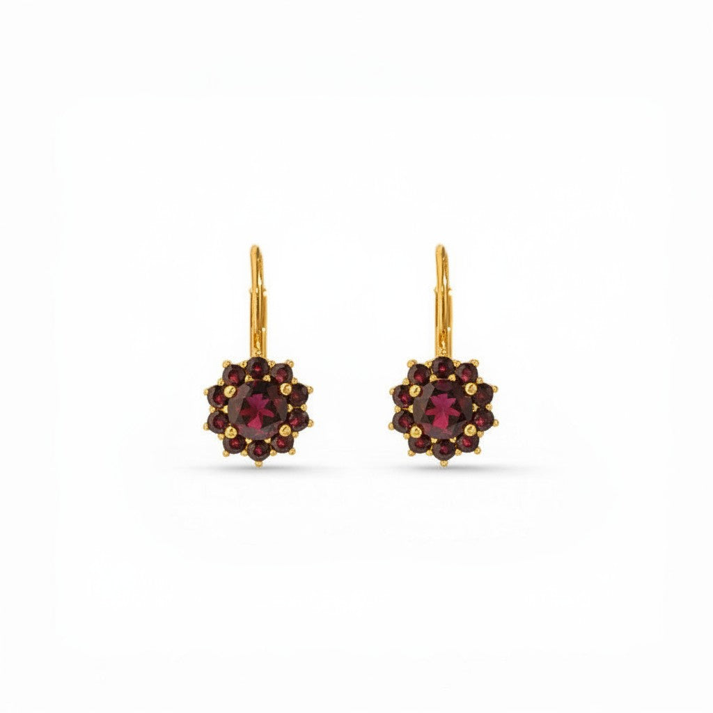 Sophia Schneider Joyas 14K gold dangle earrings with a central round garnet surrounded by ten smaller garnets in a floral halo design.
