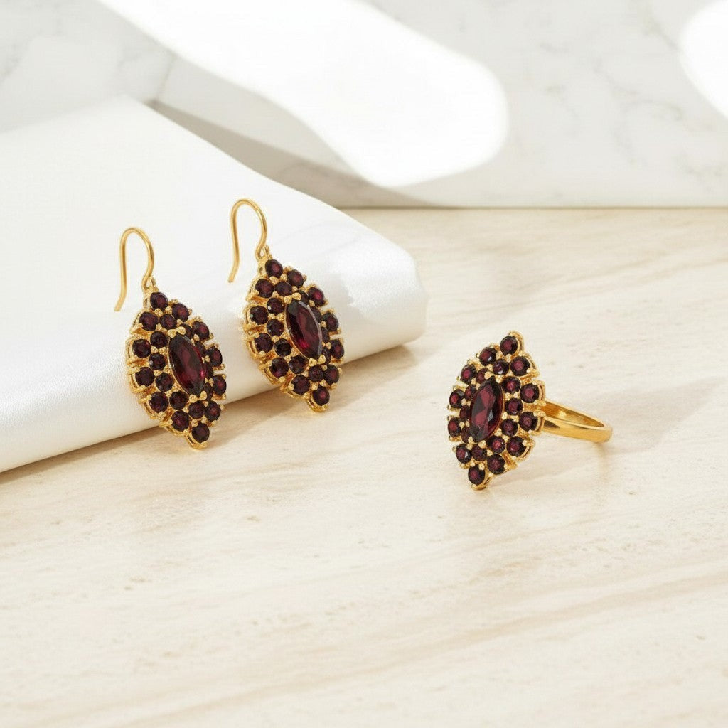 Sophia Schneider Joyas 14K gold earrings and ring set with marquise-cut garnet and halo of small garnets.
