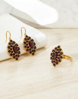 Sophia Schneider Joyas 14K gold earrings and ring set with marquise-cut garnet and halo of small garnets.