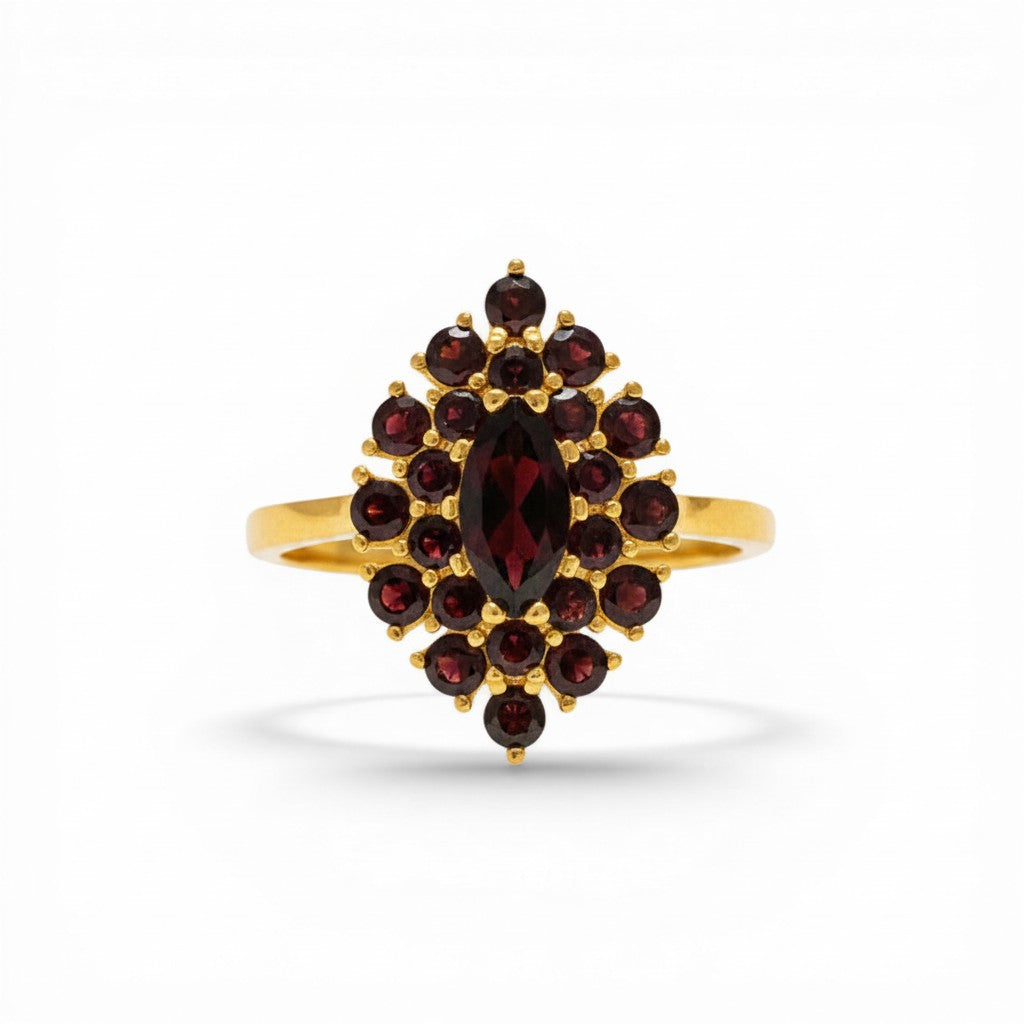Sophia Schneider Joyas 14K gold ring with marquise-cut garnet center stone surrounded by smaller garnets in a floral cluster design.