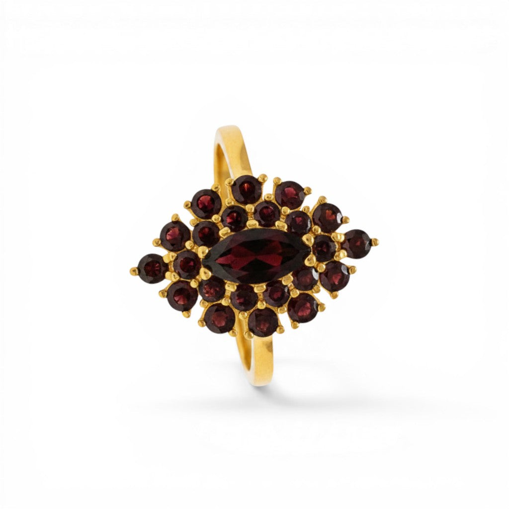 Sophia Schneider Joyas 14K gold ring featuring a marquise-cut garnet center surrounded by a halo of smaller garnets in a floral cluster design.