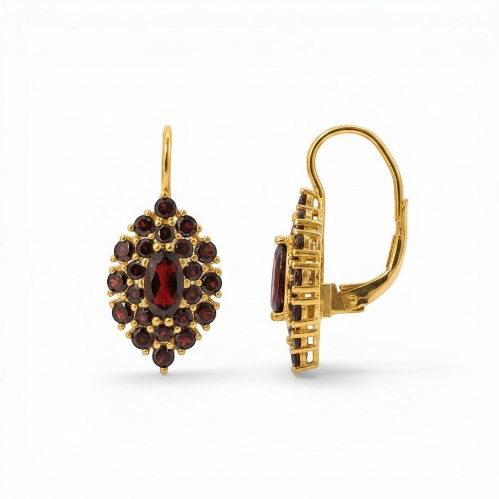 Sophia Schneider Joyas 14K gold dangle earrings featuring a marquise-cut garnet center surrounded by smaller round garnets in a floral cluster design.