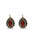Sophia Schneider Joyas 14K gold dangle earrings with pear-cut garnet center and surrounding smaller garnets.