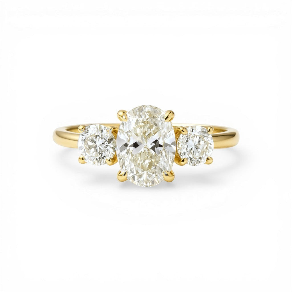 Sophia Schneider Joyas 18K yellow gold ring with a 1.08 ct oval lab-created diamond center stone and two round side stones.
