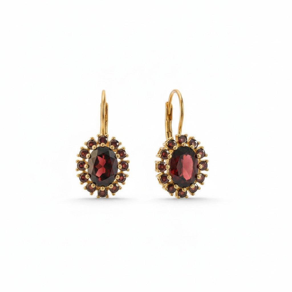 Sophia Schneider Joyas oval 14K gold dangle earrings with central oval garnet surrounded by halo of small garnets.