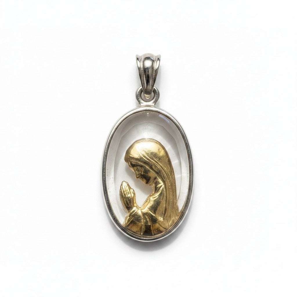 Sophia Schneider Joyas oval pendant with a gold-plated Virgin Mary praying inside a crystal and silver frame.
