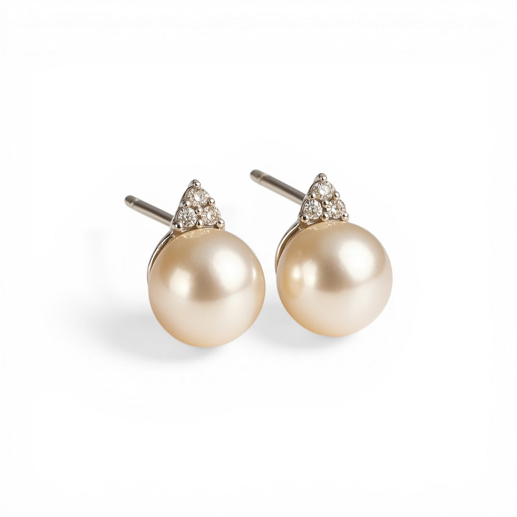 Sophia Schneider Joyas 14K white gold stud earrings with pearl and trio of brilliant-cut diamonds.