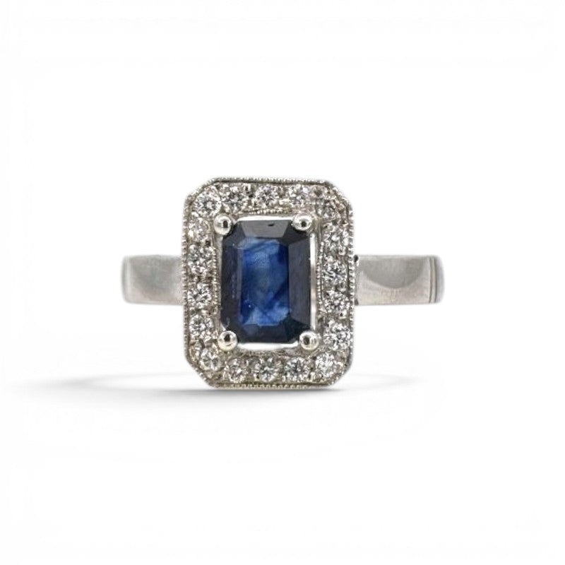 Sophia Schneider Joyas platinum halo ring with emerald-cut sapphire and 0.18 ct diamonds.