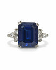 Sophia Schneider Joyas platinum ring with emerald-cut sapphire and surrounding diamonds.