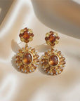 Sophia Schneider Joyas statement earrings with amber, citrine, and zircon stones in silver.