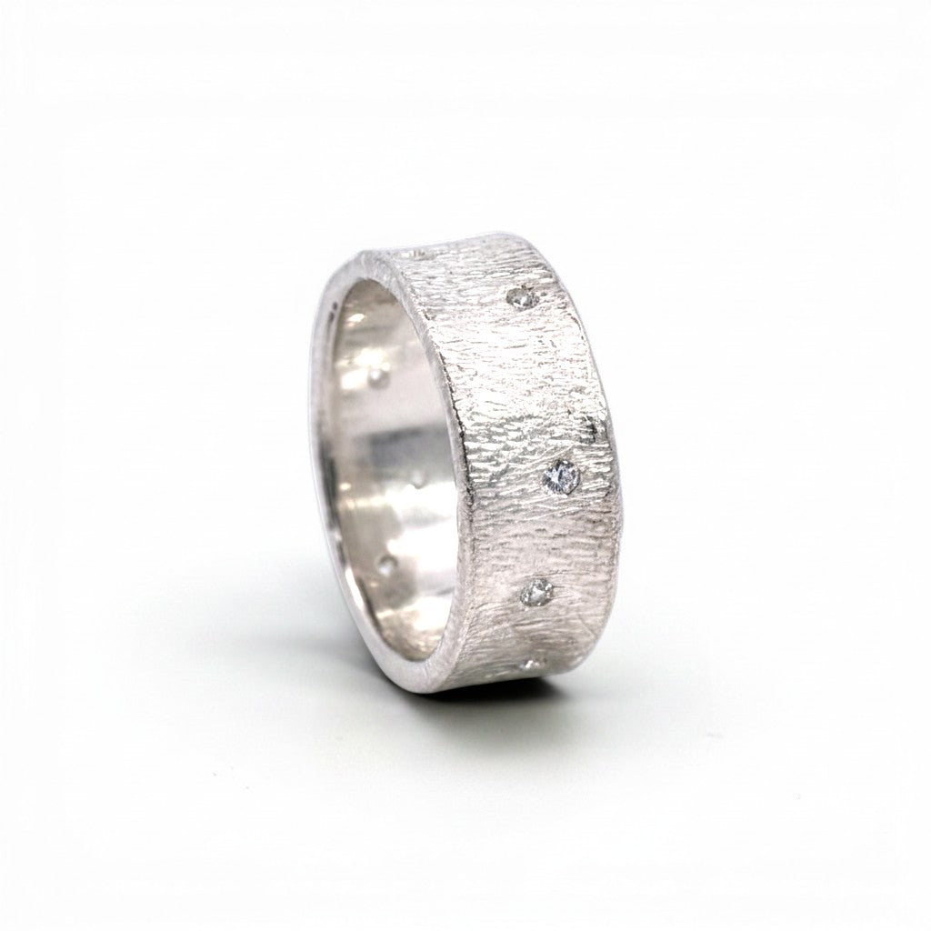 Sophia Schneider Joyas textured silver band ring with scattered clear cubic zirconia stones.