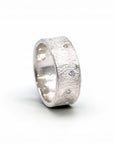 Sophia Schneider Joyas textured silver band ring with scattered clear cubic zirconia stones.