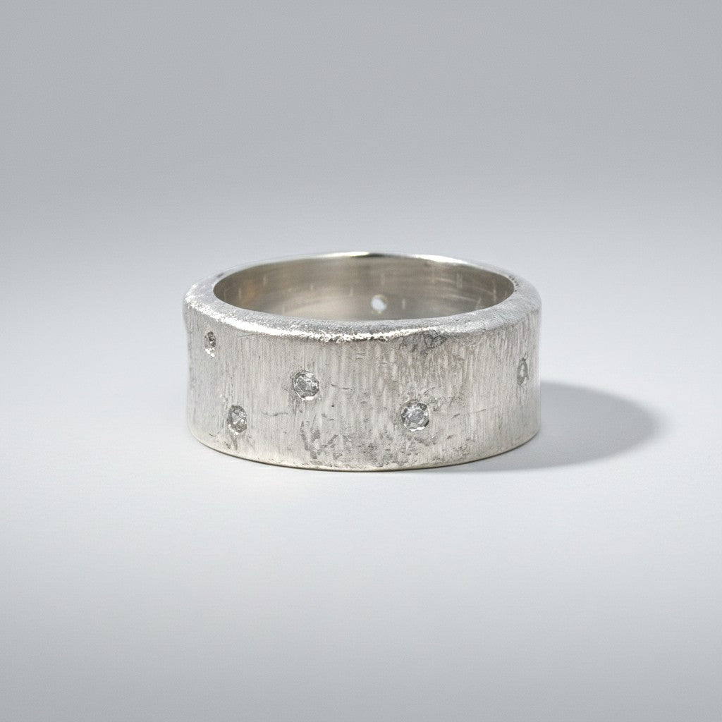 Sophia Schneider Joyas textured silver band ring with scattered cubic zirconia stones.