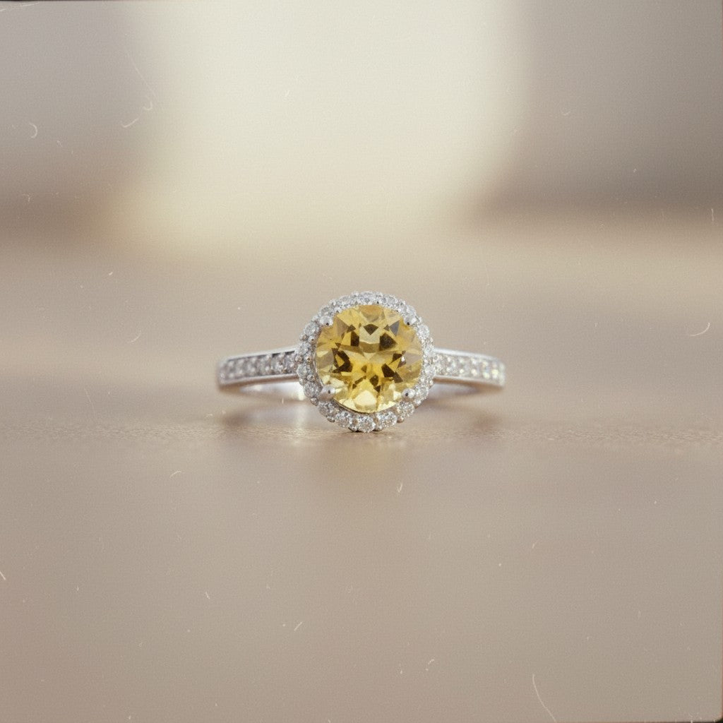 Sophia Schneider Joyas silver ring with a 1.65 ct round yellow citrine center stone surrounded by small white stones.