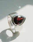 Sophia Schneider Joyas silver ring with a 6.53 ct pear-cut garnet gemstone.