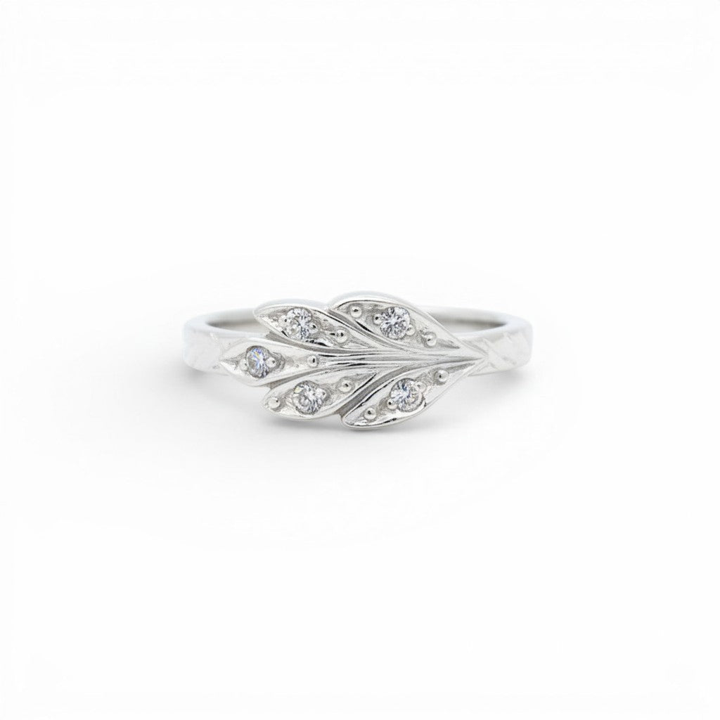 Sophia Schneider Joyas silver ring with carved leaf design and clear cubic zirconia stones.