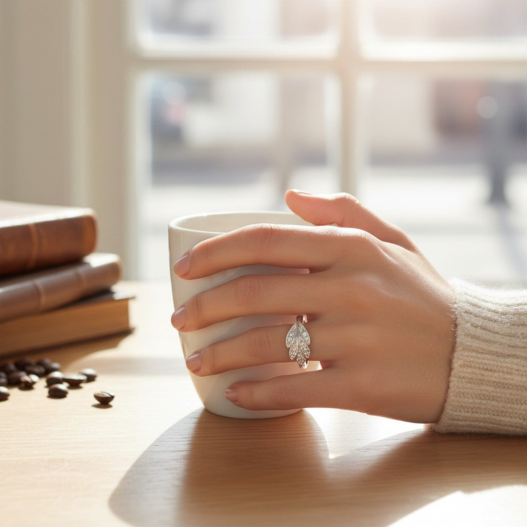 Sophia Schneider Joyas silver ring with carved leaf design and cubic zirconia accents.