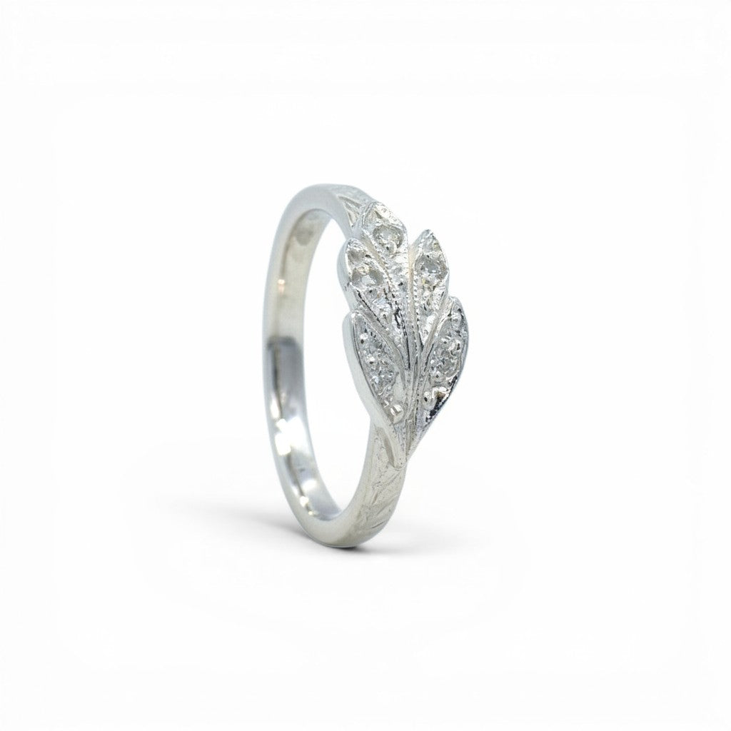 Sophia Schneider Joyas silver ring with carved leaf design and cubic zirconia stones.