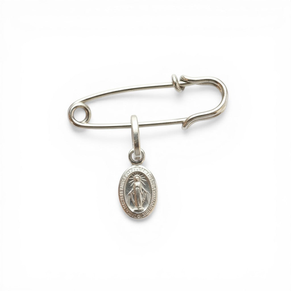 Sophia Schneider Joyas silver safety pin brooch with a Miraculous Medal charm featuring the Virgin Mary.