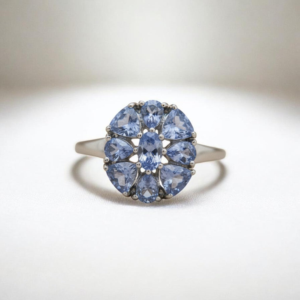 Sophia Schneider Joyas silver ring with oval and pear-shaped tanzanite stones arranged in a floral pattern.