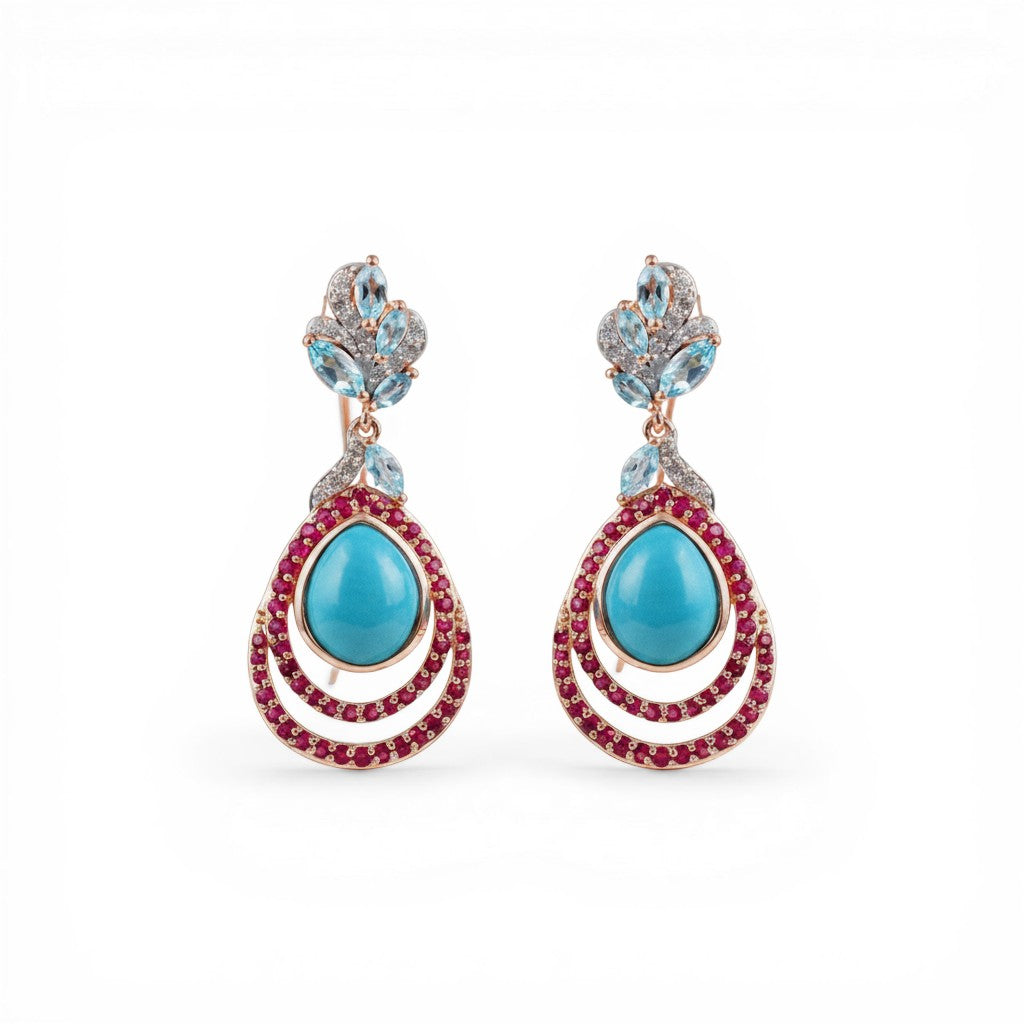 Sophia Schneider Joyas teardrop earrings with turquoise, ruby, topaz, and zircon stones set in silver.