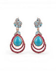 Sophia Schneider Joyas teardrop earrings with turquoise, ruby, topaz, and zircon stones set in silver.