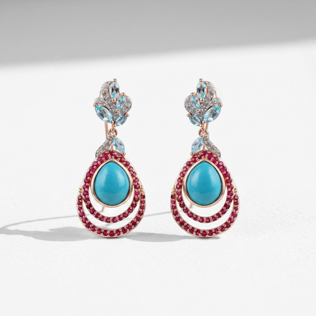 Sophia Schneider Joyas rose gold drop earrings with turquoise, ruby, topaz, and cubic zirconia.