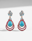 Sophia Schneider Joyas rose gold drop earrings with turquoise, ruby, topaz, and cubic zirconia.