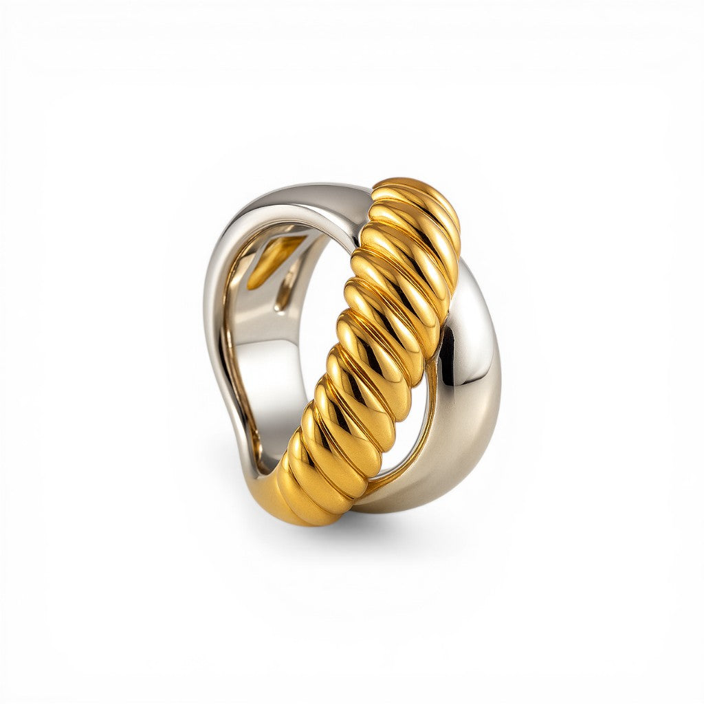 Sophia Schneider Joyas chunky two-tone ring with intertwined silver and gold bands, one twisted.