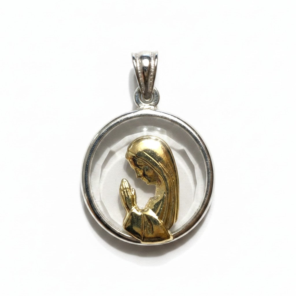 Sophia Schneider Joyas round medal featuring a praying Virgin Mary in gold-plated metal within a crystal and silver frame.